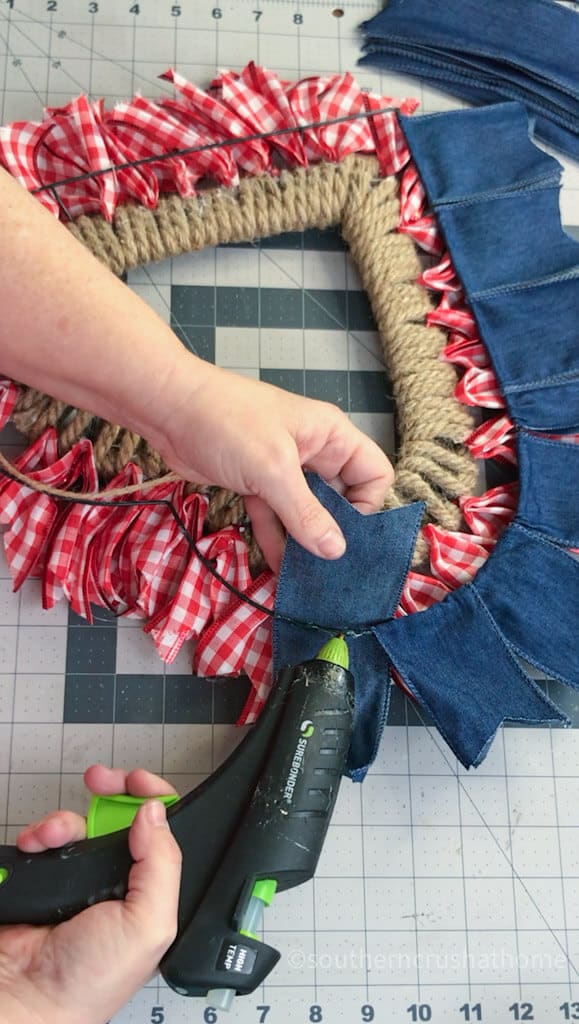 securing denim ribbon to wreath