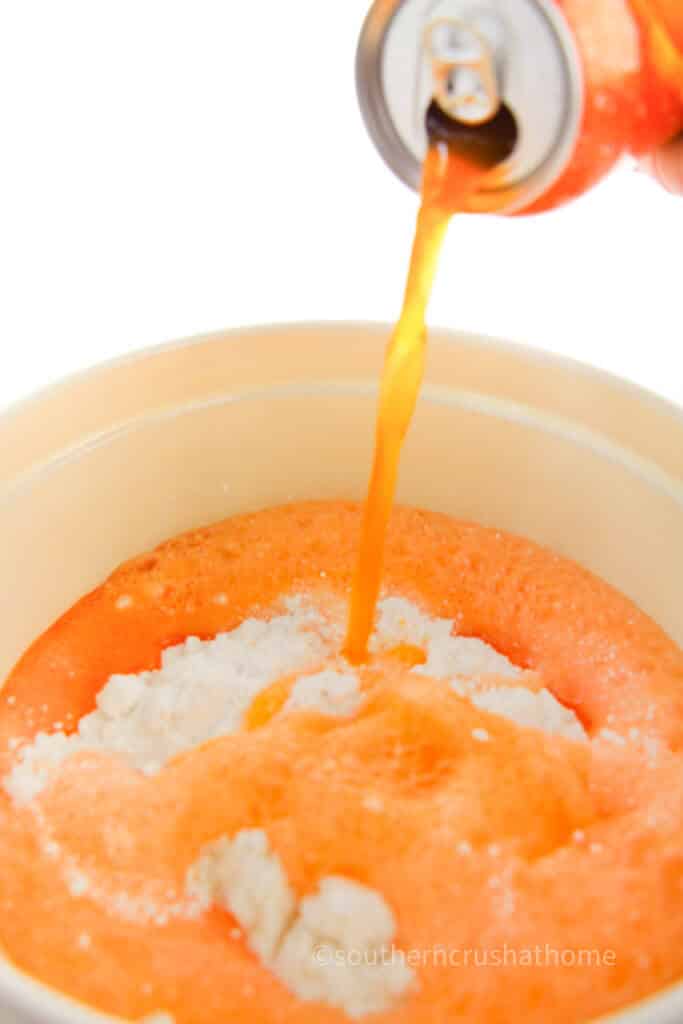 pouring sunkist into cake mix
