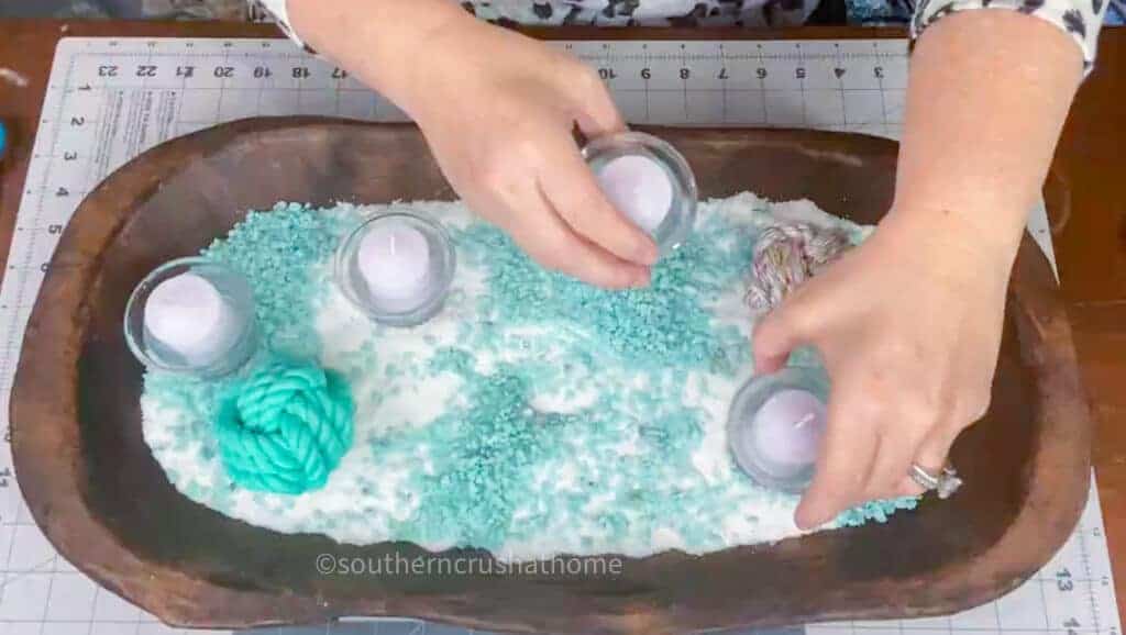 adding candles to dough bowl