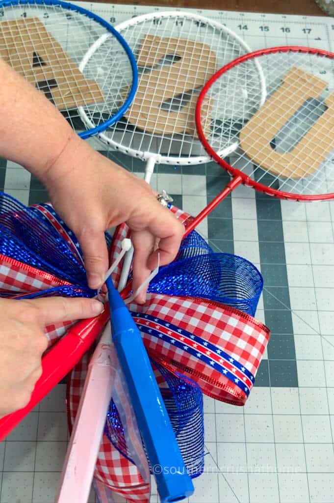 attaching bow to summer wreath