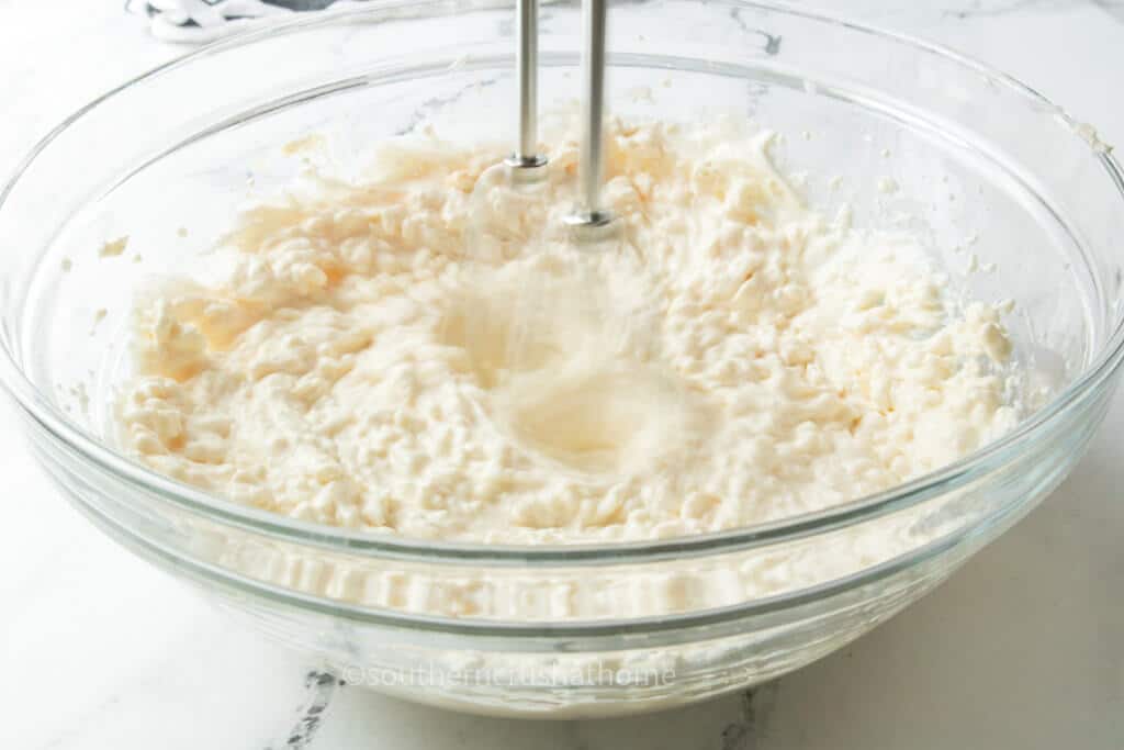 mixing cream cheese and sour cream