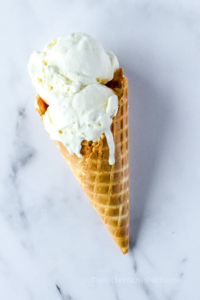 melting vanilla ice cream in a waffle cone