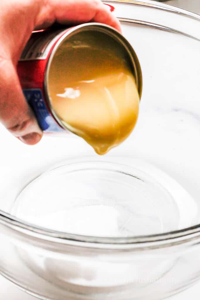 sweetened condensed. milk pouring from can