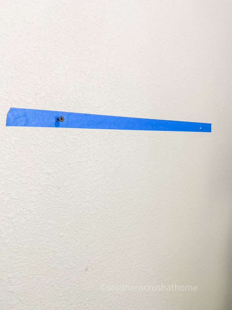 marking wall with painter's tape for screws