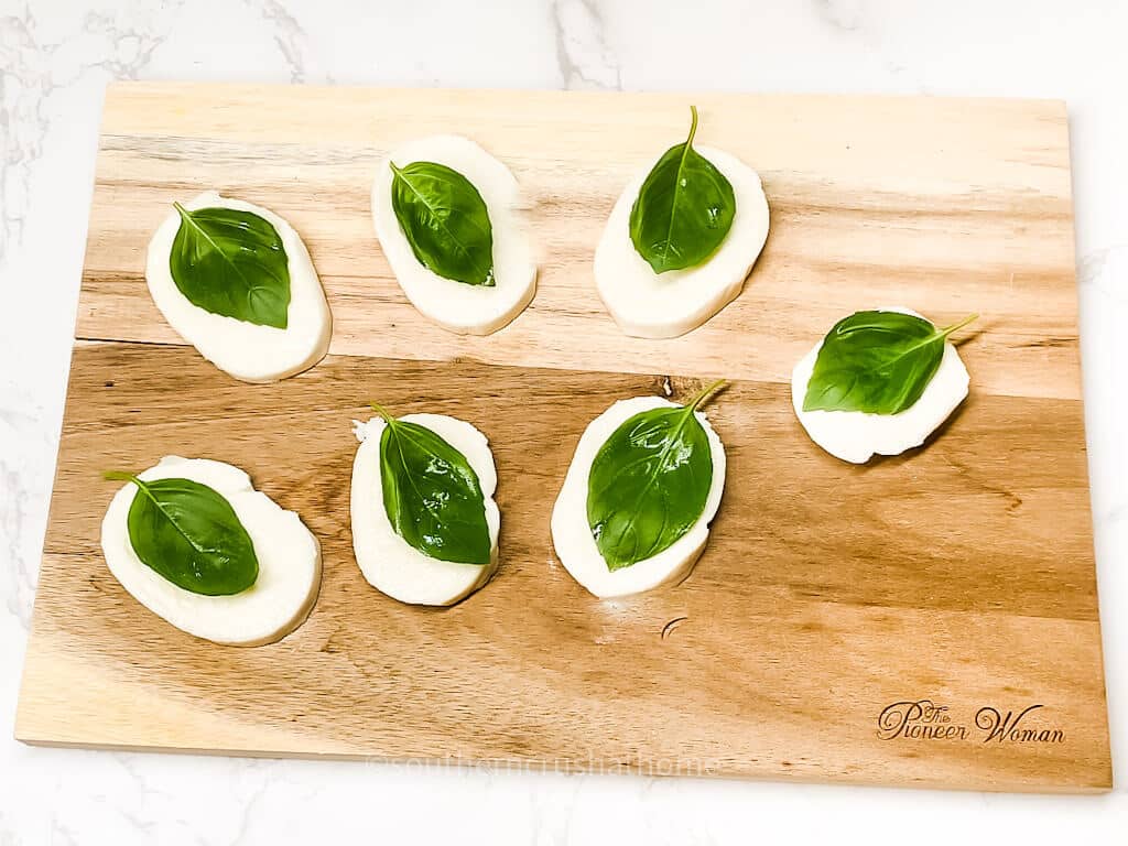 basil leaves on mozzarella slices
