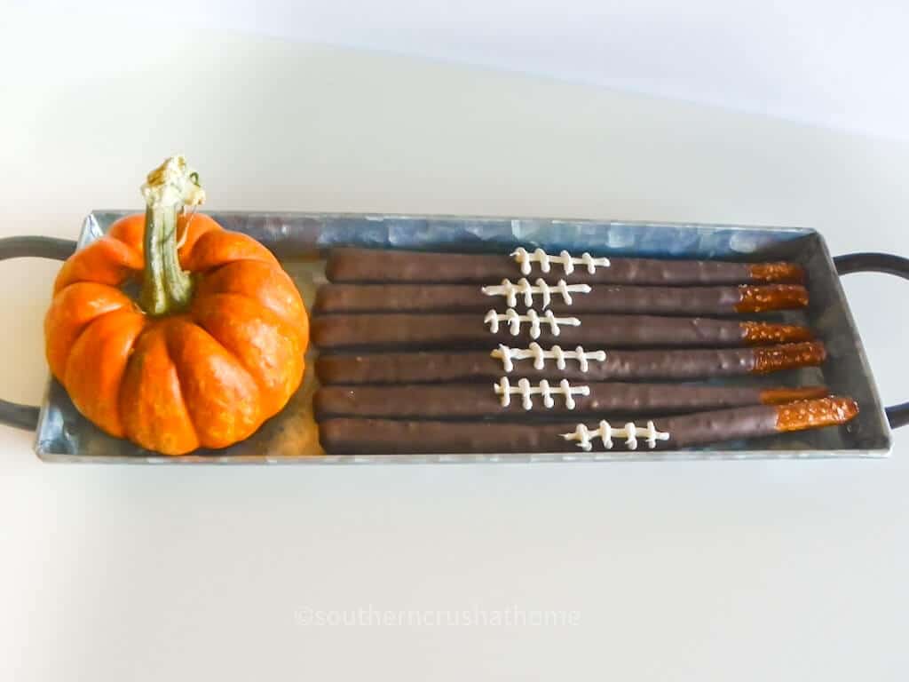 football pretzel rods next to pumpkin