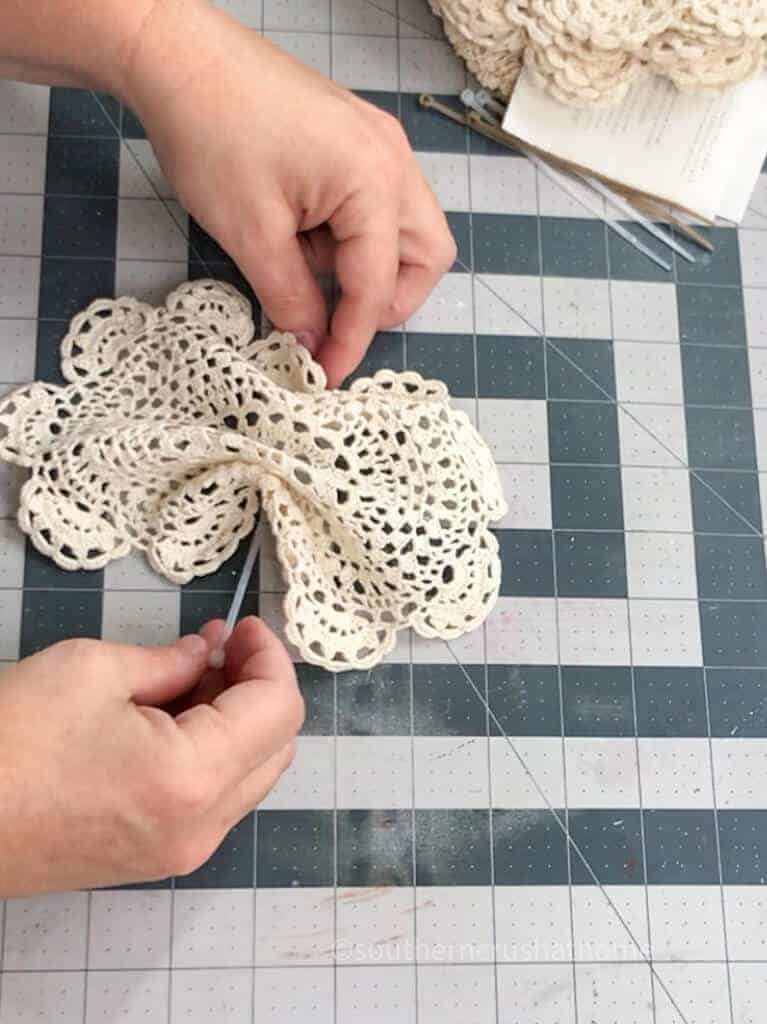 threading ziptie under doily