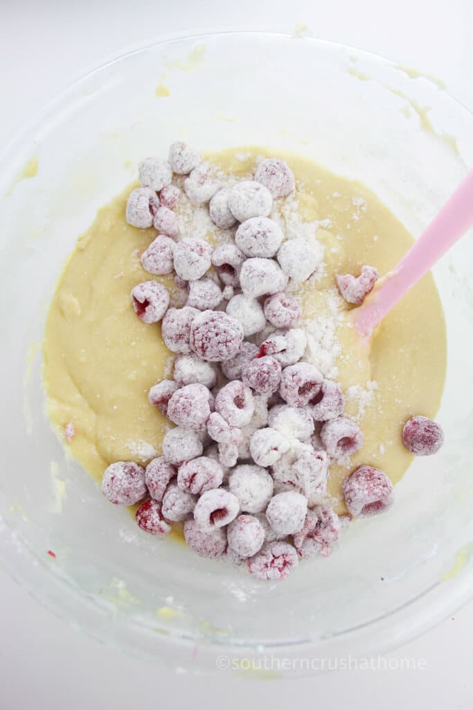 stirring in raspberries into batter