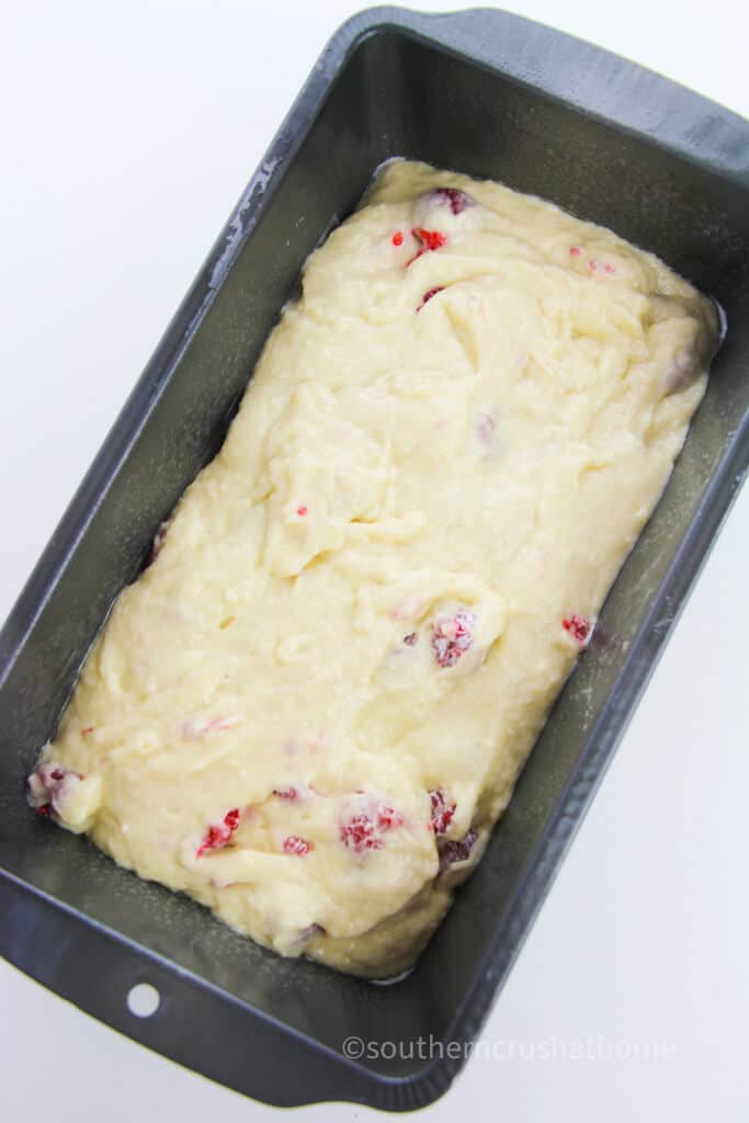 lemon raspberry cake batter in loaf pan