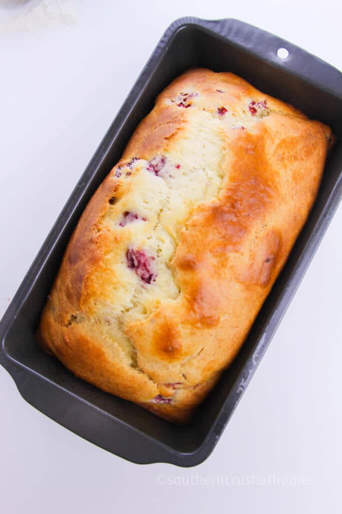 lemon raspberry cake cooling in loaf pan