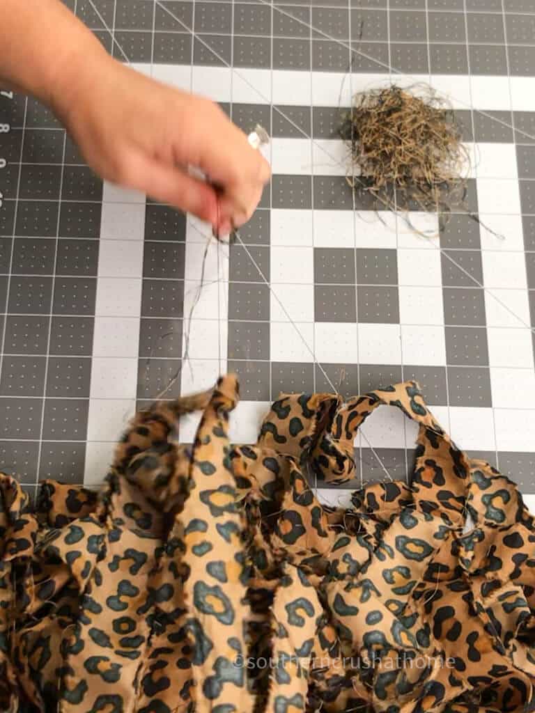 removing strings from fabric