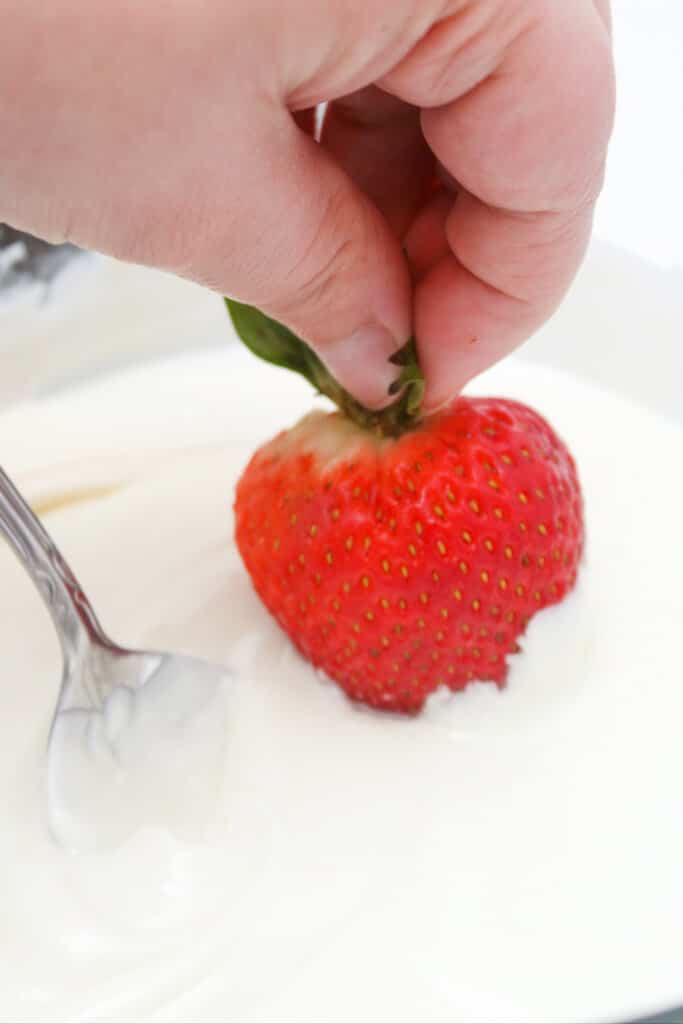 dipping strawberry in white chocolate