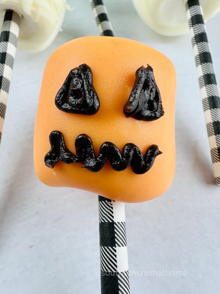 close up of jack o lantern chocolate covered marshmallow