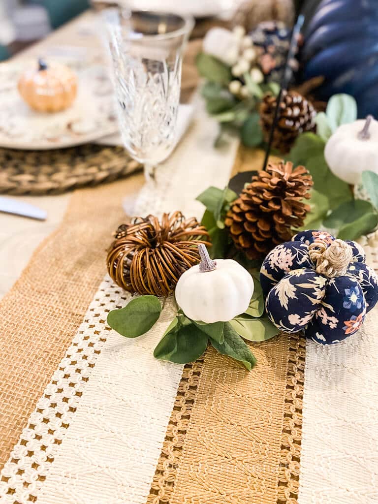 pumpkins scattered on table runner