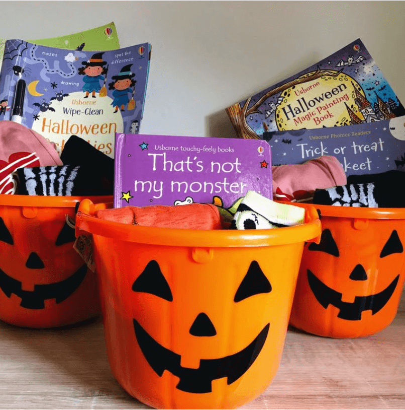 Orange pumpkin bucket with books