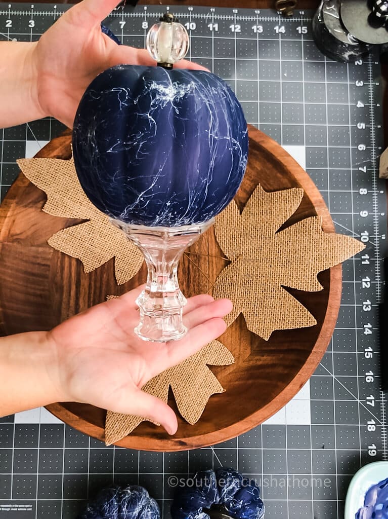 adding glass candlestick to blue pumpkin