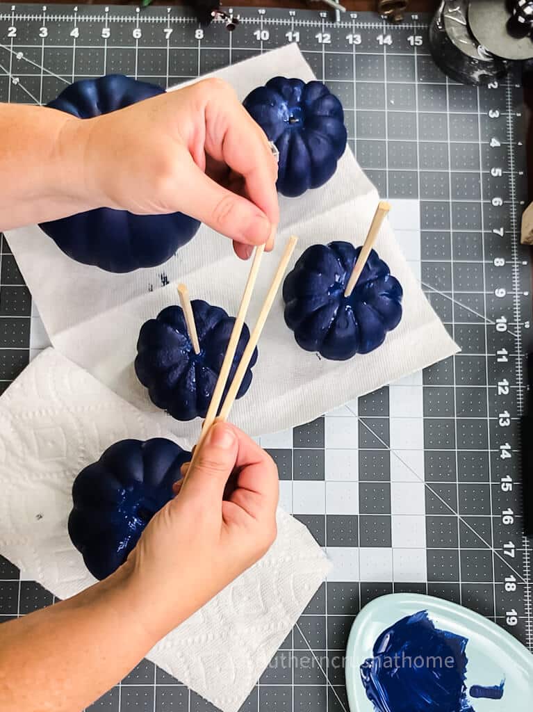 adding chopstick to blue pumpkin