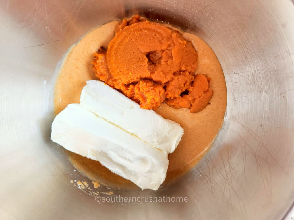 cream cheese and pumpkin in mixing bowl