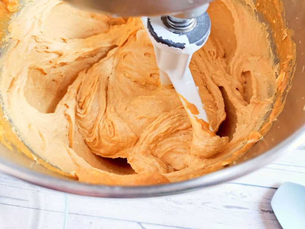 mixing pumpkin pie cheesecake