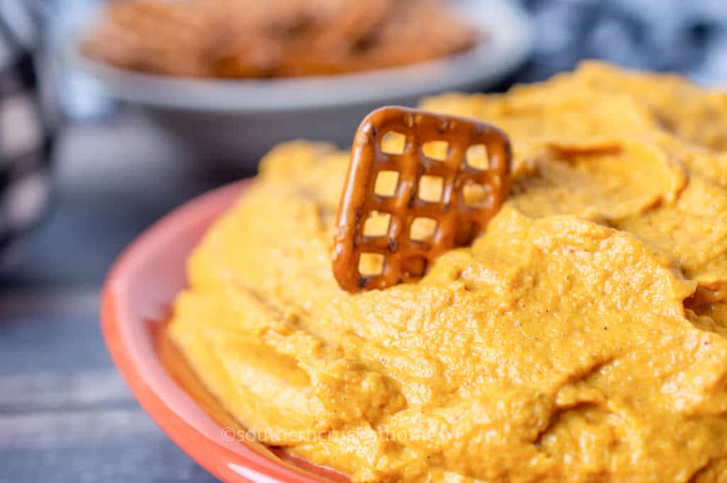 close up of pretzel in pumpkin fluff dip