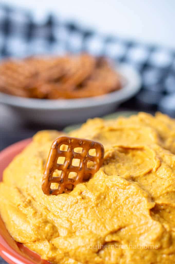 pretzel dipped into pumpkin pie dip