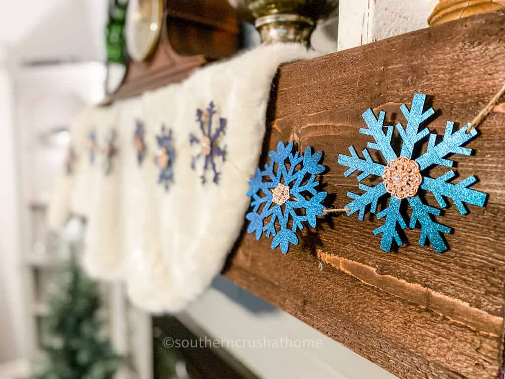 side angle of snowflake garland on mantle