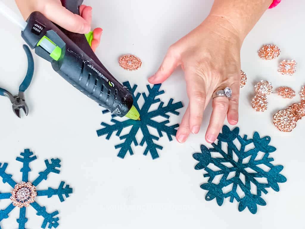 gluing embellishments onto snowflake