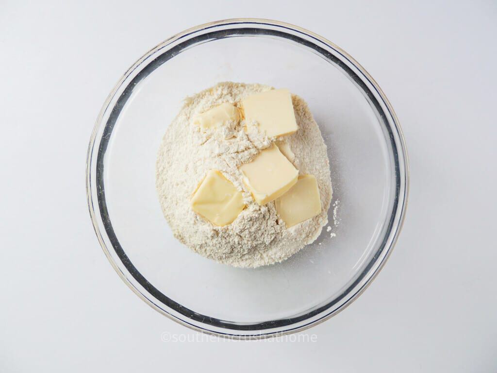 cold butter slices on top of flour