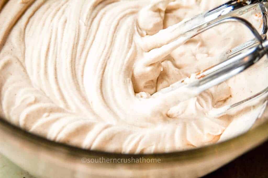 up close of beaters in cinnamon whipped cream