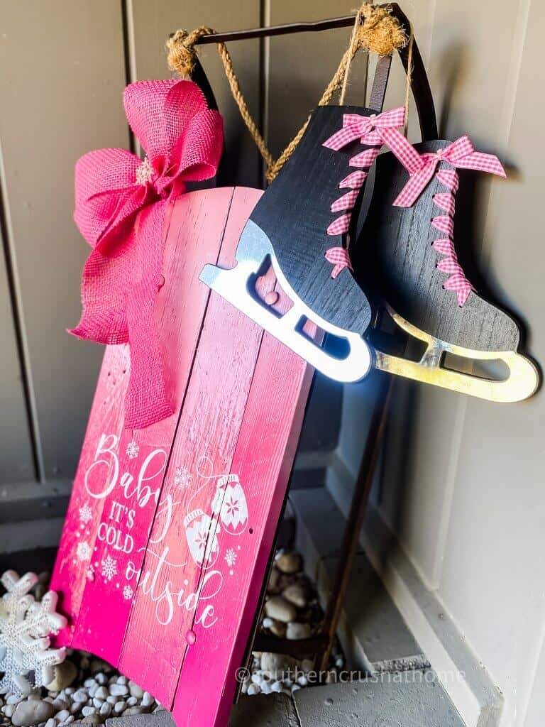 another side view of pink christmas snow sled with skates and bow