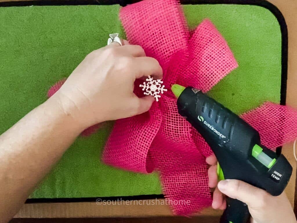 adding snowflake bling to center of pink burlap bow