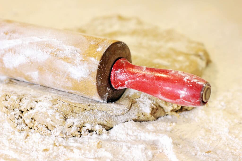rolling out gingerbread dough with vintage rolling pin