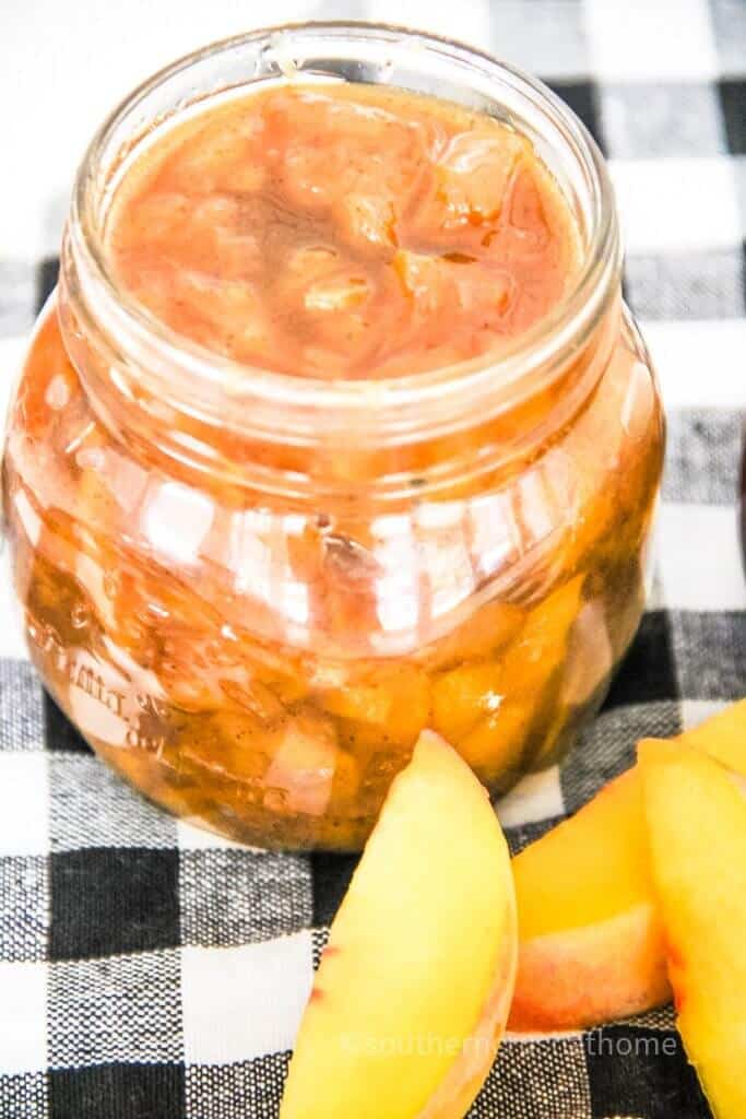 close up of peach jam in jar