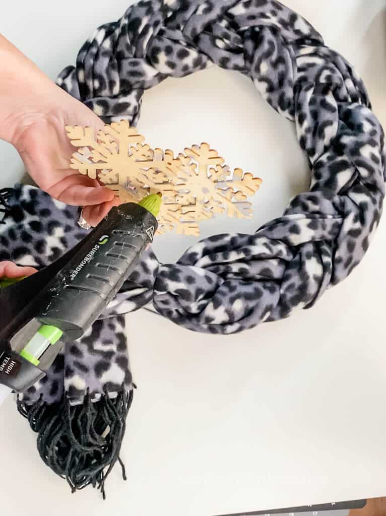 gluing on wooden snowflakes