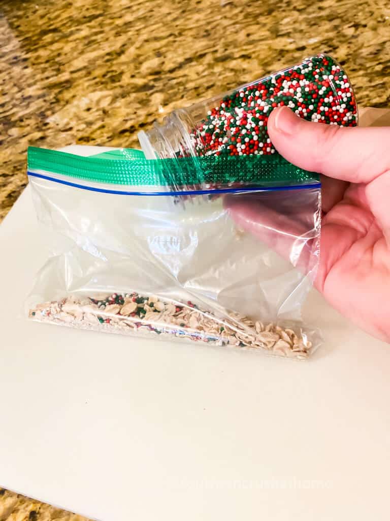 adding red and green sprinkles to reindeer food