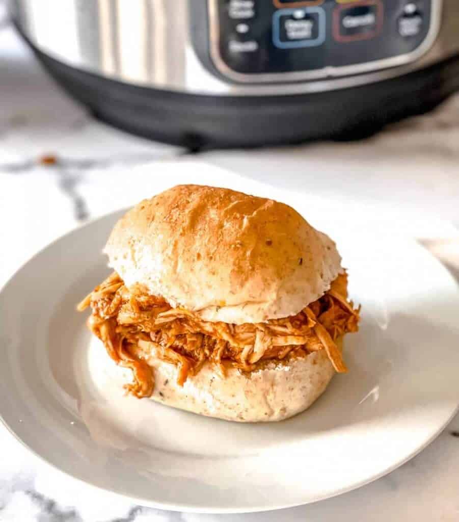 Two-ingredient-bbq-chicken-instant-pot-on-plate-in-bun