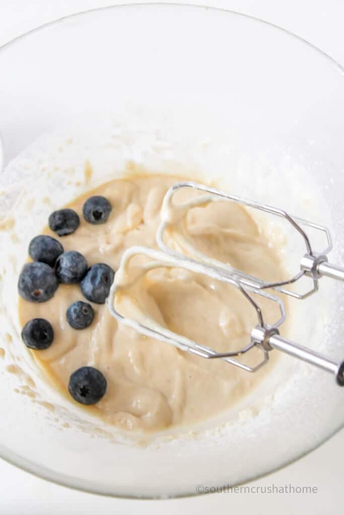 mixing in blueberries to pancake batter