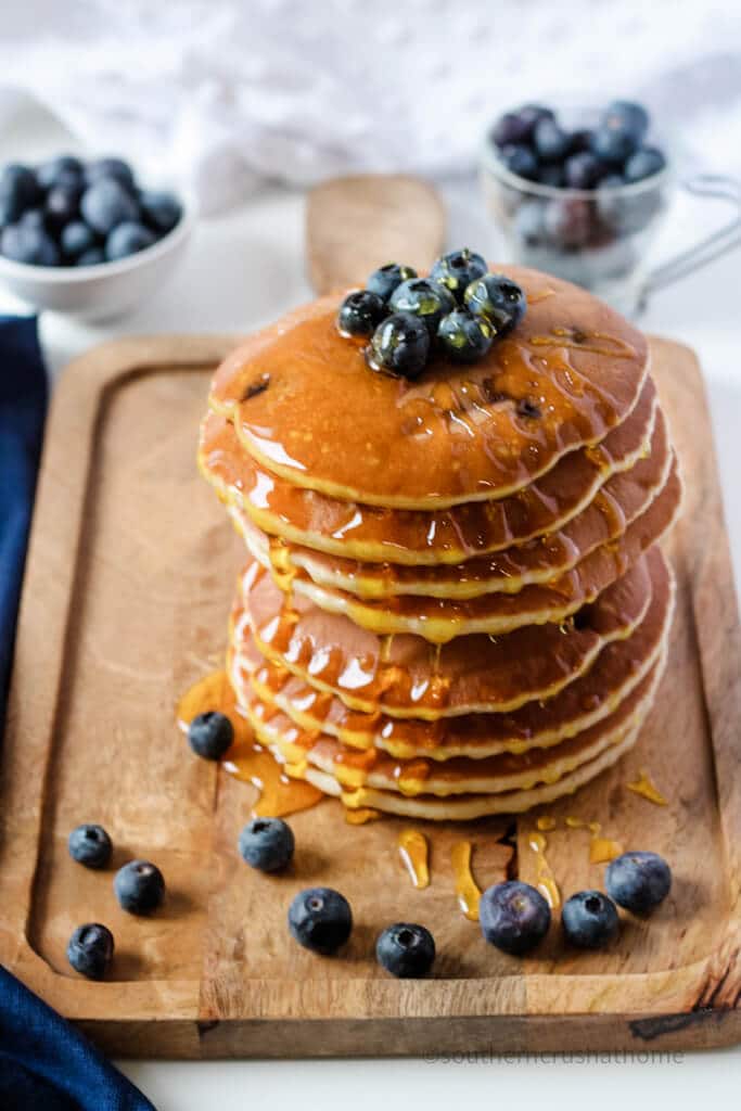 syrup dripping from pancakes with blueberries