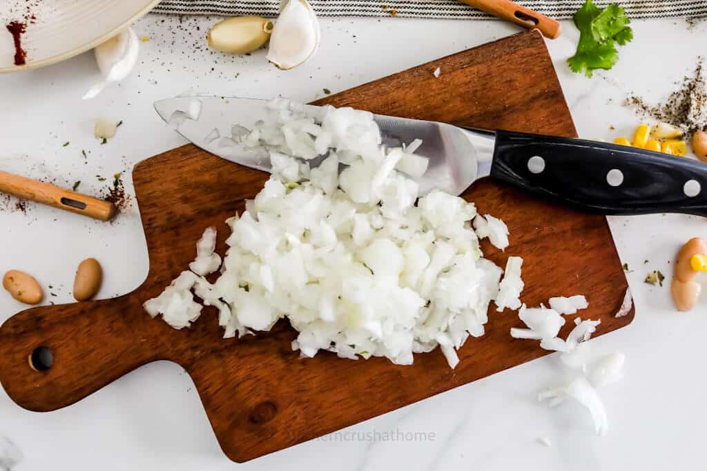 chopped white onion on cutting board
