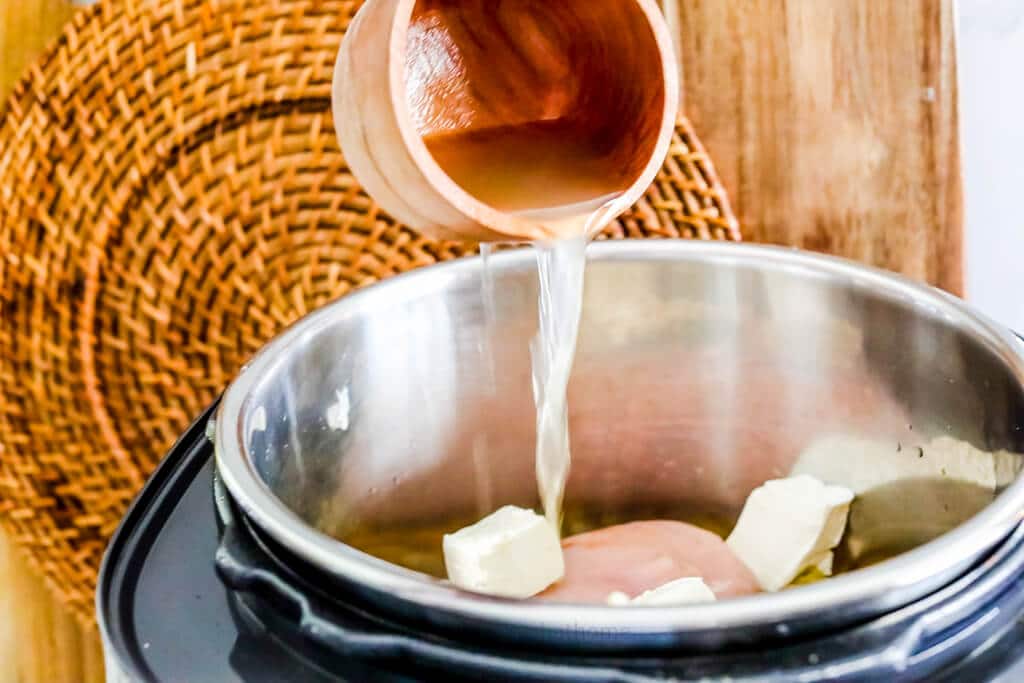 pouring chicken broth