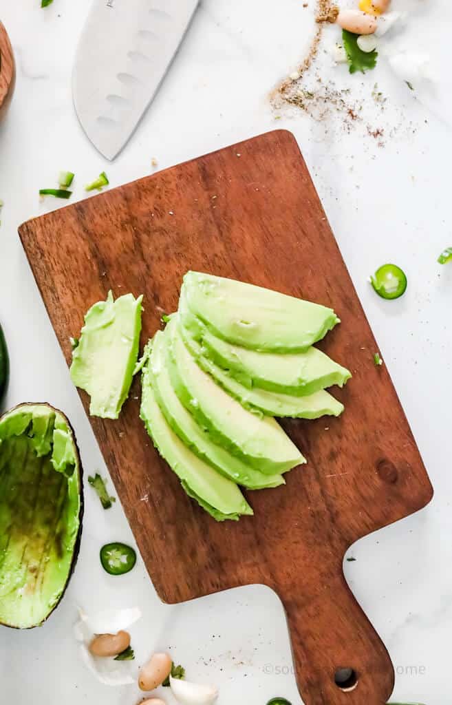 sliced avocados on a cutting board