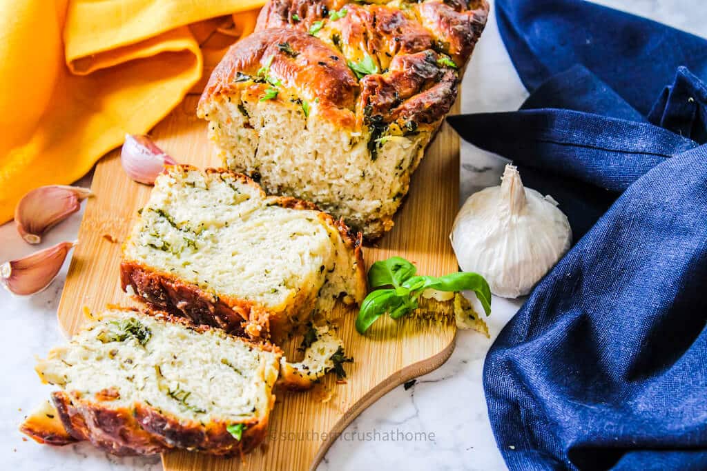 texas toast garlic bread sliced on board with garlic clove