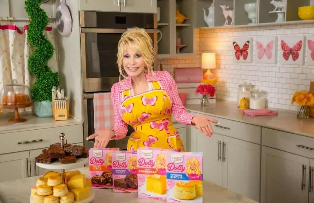 dolly parton posing with her baking mix collection