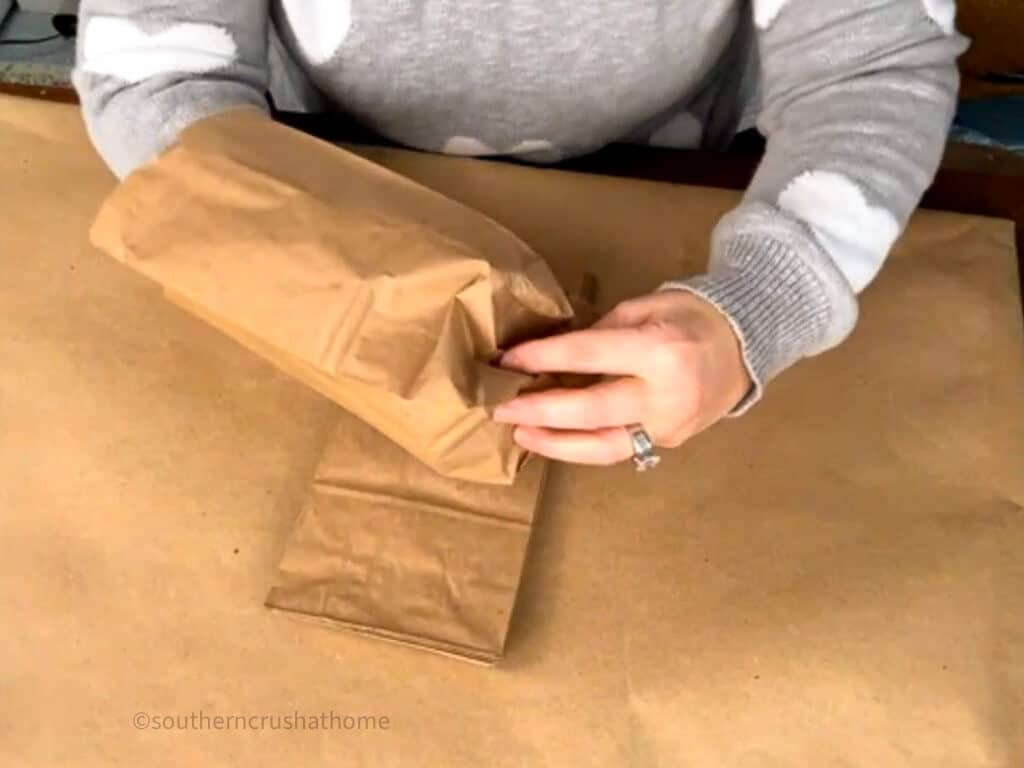 pinching bottom of paper bag