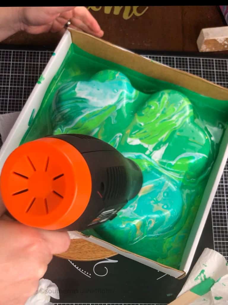 using a heat tool to spread the paints
