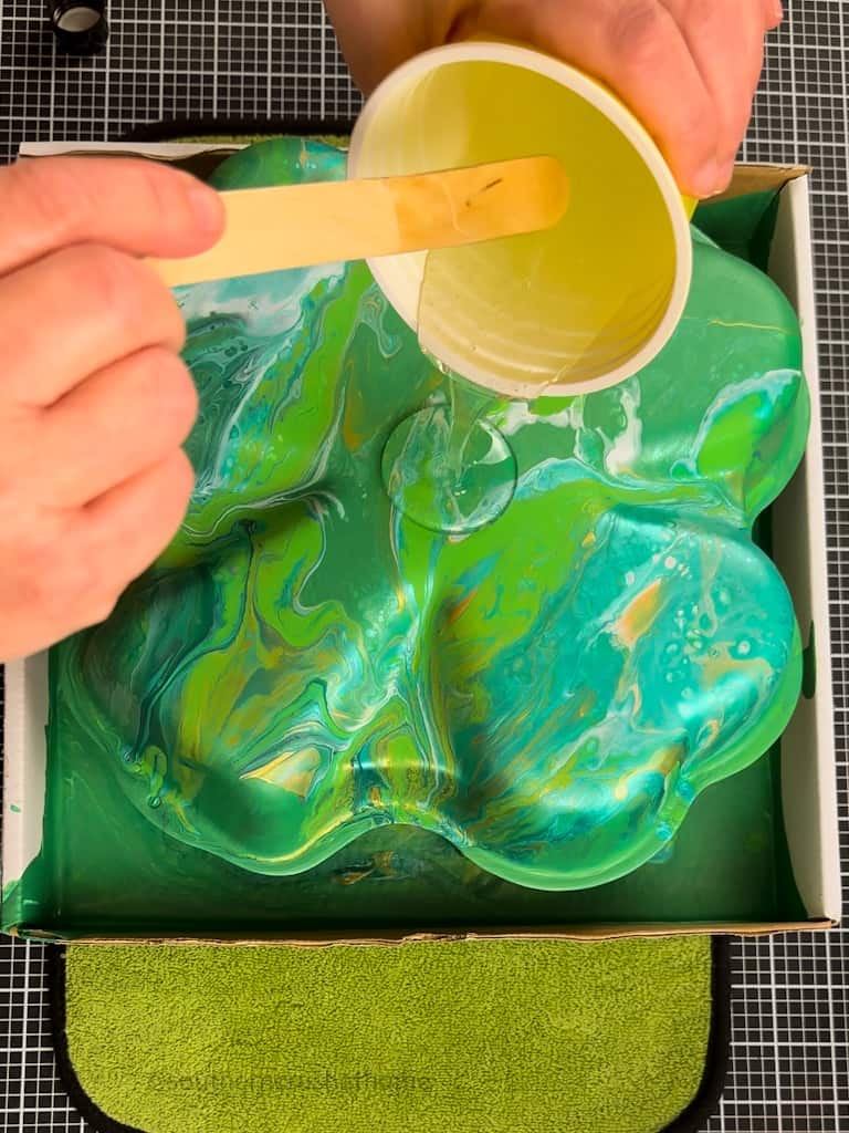 pouring resin over Acrylic Pour Painting