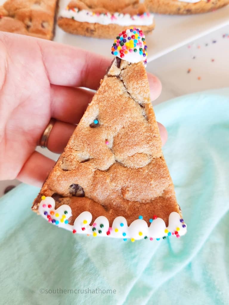 holding a Birthday Cookie Cake slice