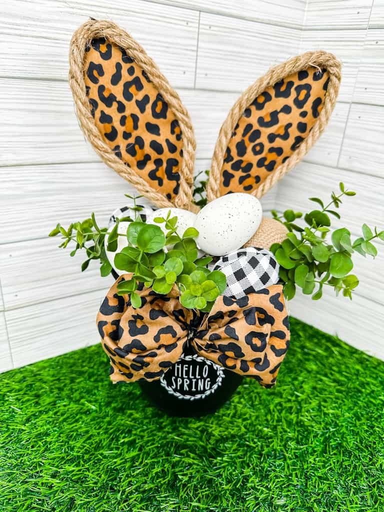 Easter Bunny Ears in a dollar tree pot with easter eggs and greenery