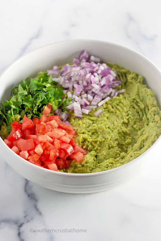 bowl with ingredients for homemade guacamole