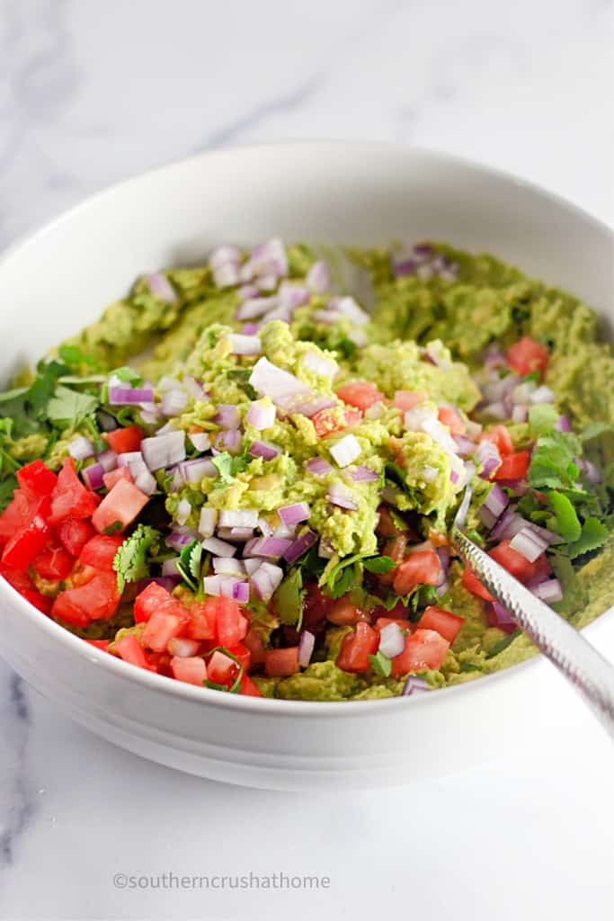 stirring ingredients for homemade guacamole